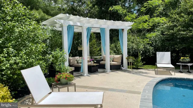 a view of a patio with table and chairs and potted plants
