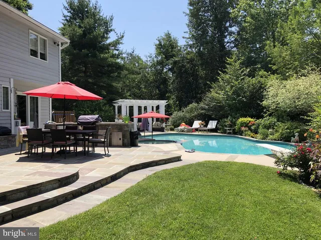 a view of swimming pool with sitting area and furniture