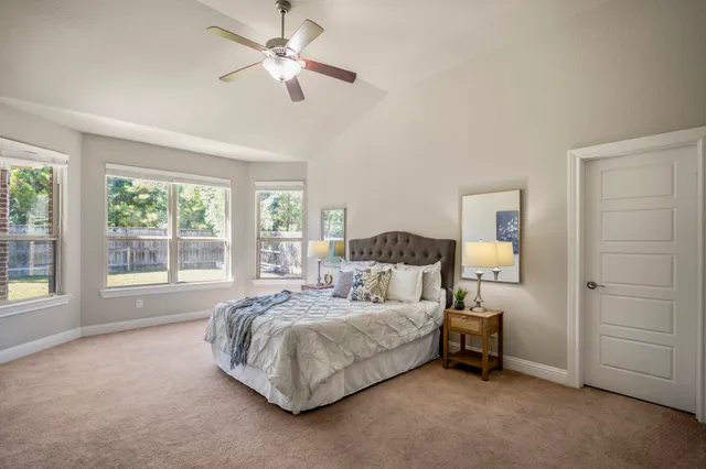 a bedroom with a bed and a chandelier