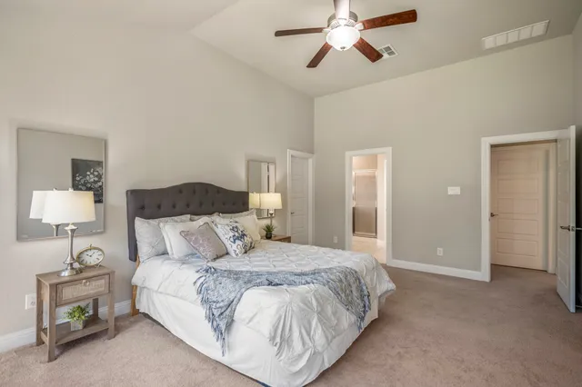 a bedroom with a bed and a lamp