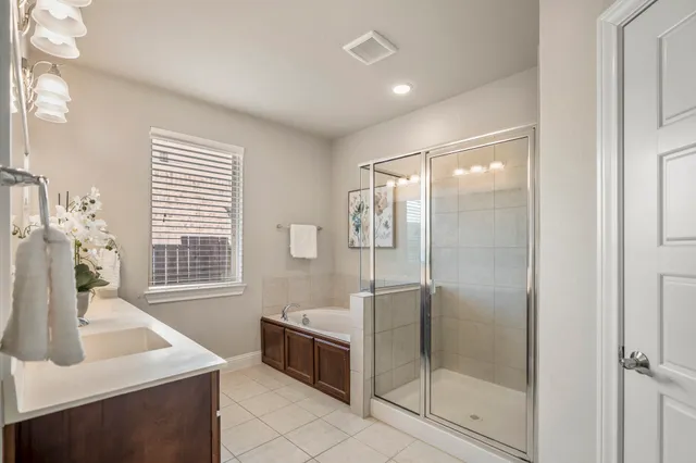 a bathroom with a shower sink and mirror