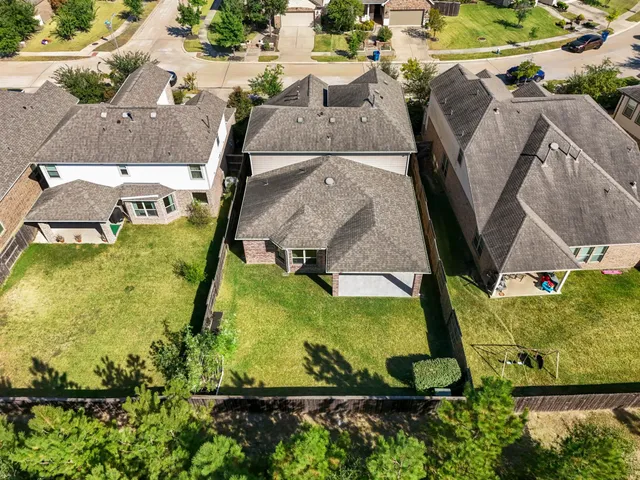 an aerial view of residential houses with outdoor space