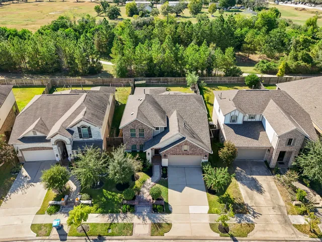 an aerial view of house with swimming pool outdoor seating and yard