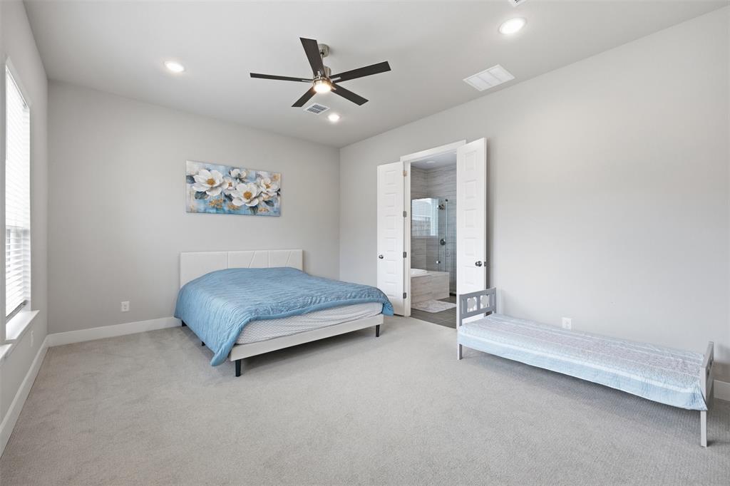 5805 Heatherwood Loop Sachse, TX 75048 - Photo 19 of 39 a bedroom with a bed and a painting on the wall