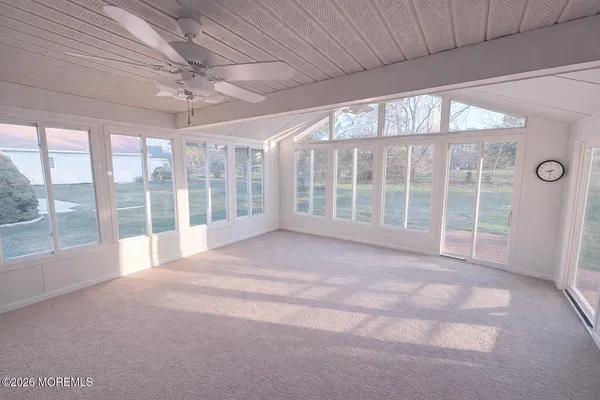 a view of an empty room with windows