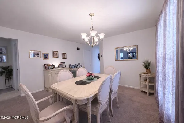 a dining room with furniture and window