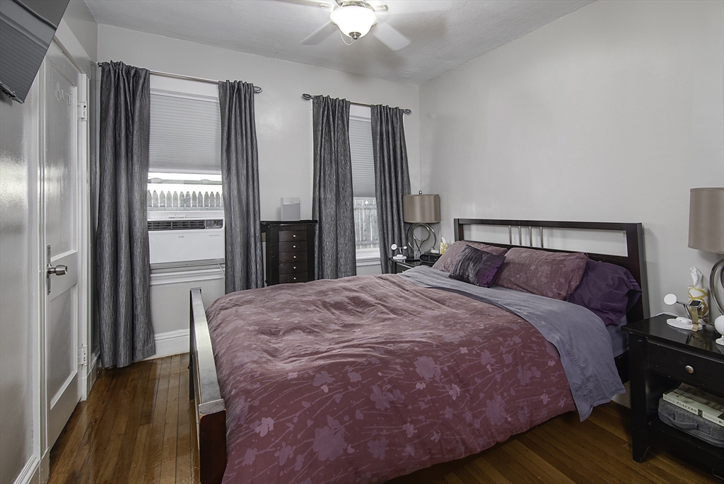 46 Winthrop Avenue Beverly, MA 01915 - Photo 13 of 29 a bedroom with a bed and a chandelier