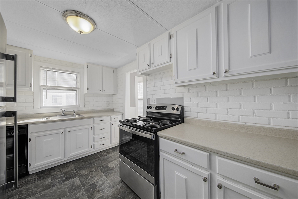 46 Winthrop Avenue Beverly, MA 01915 - Photo 14 of 29 a kitchen with cabinets appliances a sink and a counter top space