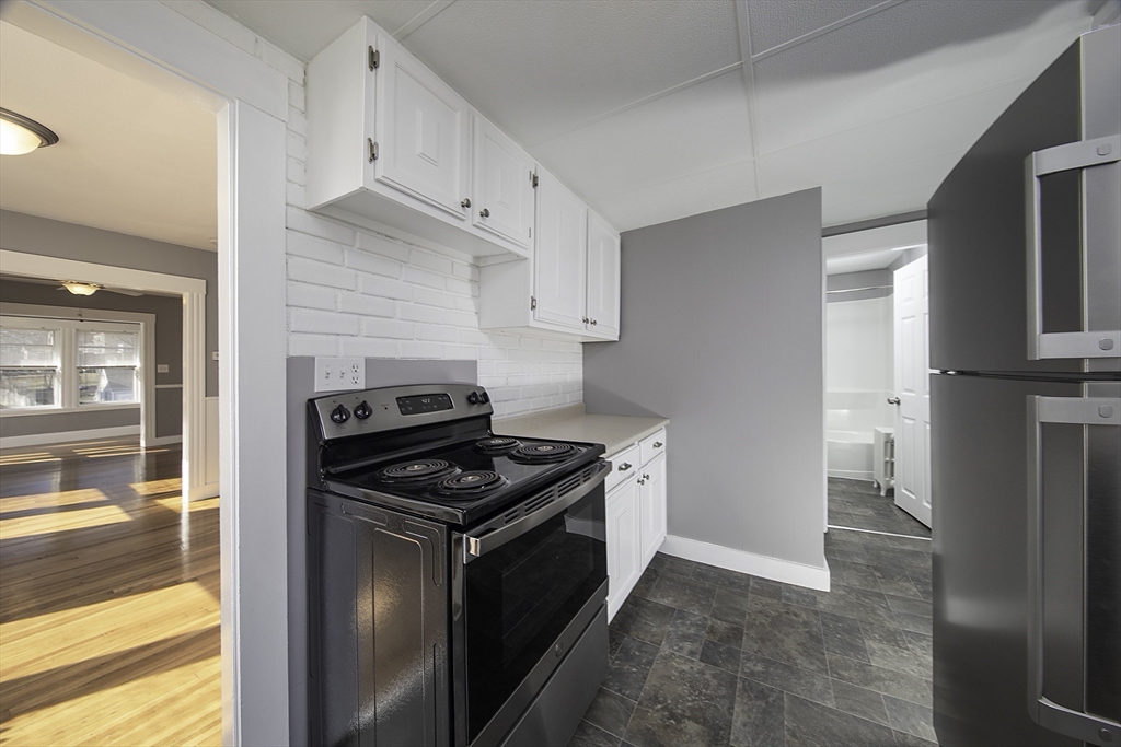 46 Winthrop Avenue Beverly, MA 01915 - Photo 15 of 29 a kitchen with a stove and a refrigerator