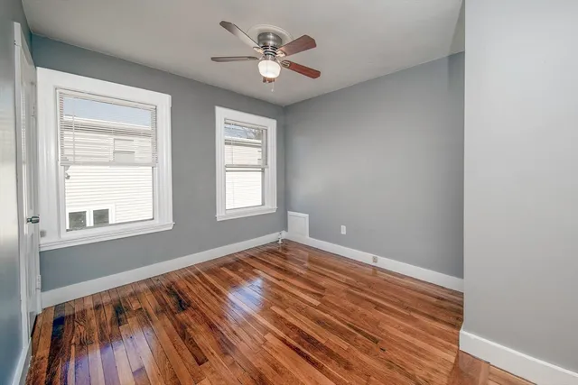 wooden floor in an empty room with a window