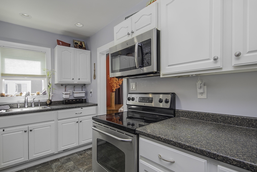 46 Winthrop Avenue Beverly, MA 01915 - Photo 4 of 29 a kitchen with stainless steel appliances granite countertop a sink and a stove