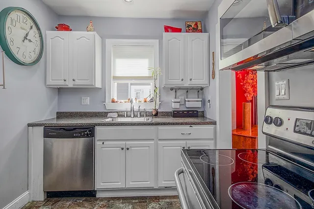 a kitchen with stainless steel appliances granite countertop a white stove top oven and sink