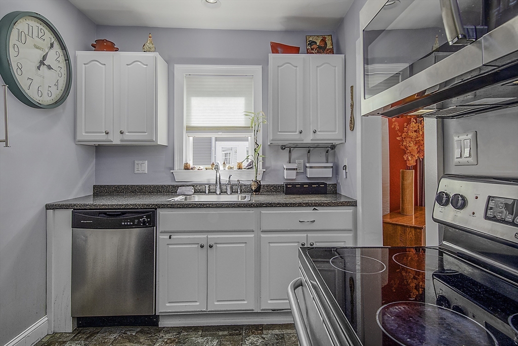 46 Winthrop Avenue Beverly, MA 01915 - Photo 6 of 29 a kitchen with stainless steel appliances granite countertop a white stove top oven and sink