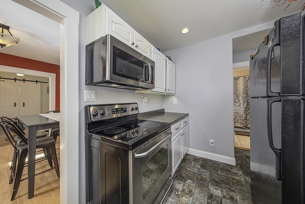 46 Winthrop Avenue Beverly, MA 01915 - Photo 7 of 29 a kitchen with stainless steel appliances granite countertop a refrigerator stove and microwave