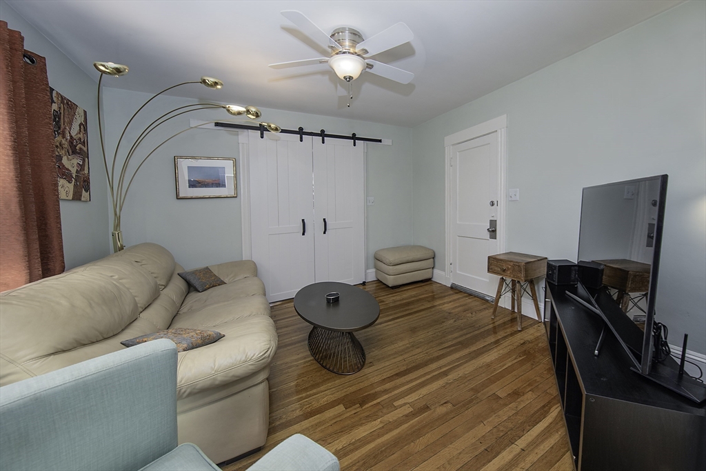 46 Winthrop Avenue Beverly, MA 01915 - Photo 8 of 29 a living room with furniture and a flat screen tv