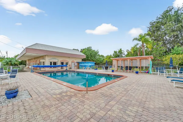 a view of a house with swimming pool and sitting area