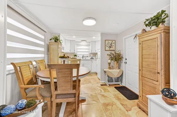 a view of a dining room with furniture and a window