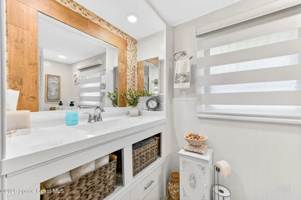 a bathroom with a sink a mirror and a shower