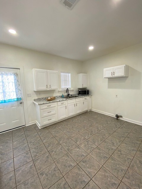 4401 Canal Street Houston, TX 77011 - Photo 6 of 20 a kitchen with granite countertop a stove a sink and a refrigerator