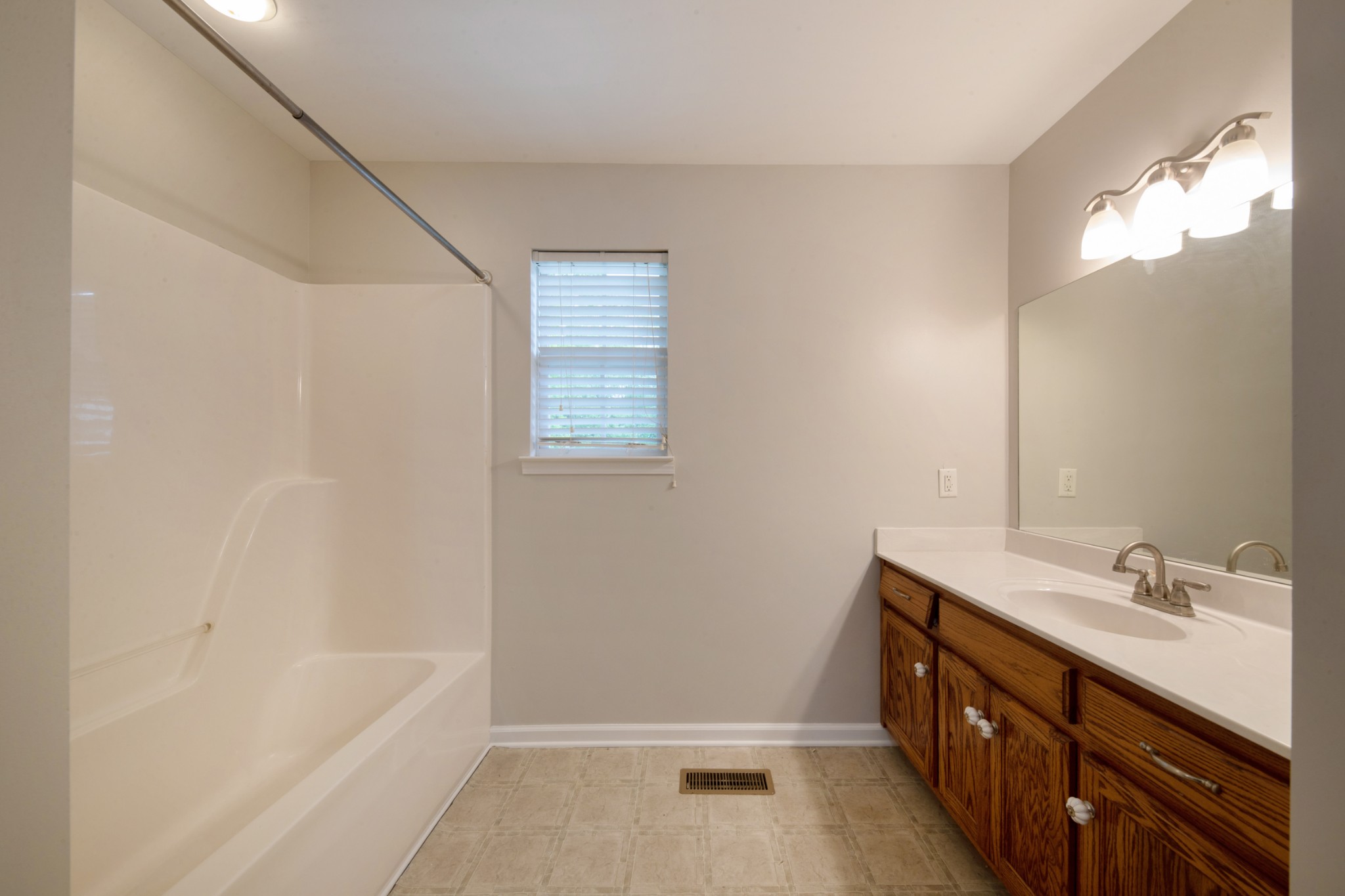 220 Black Road Dickson, TN 37055 - Photo 27 of 36 a bathroom with a bathtub sink vanity and a mirror