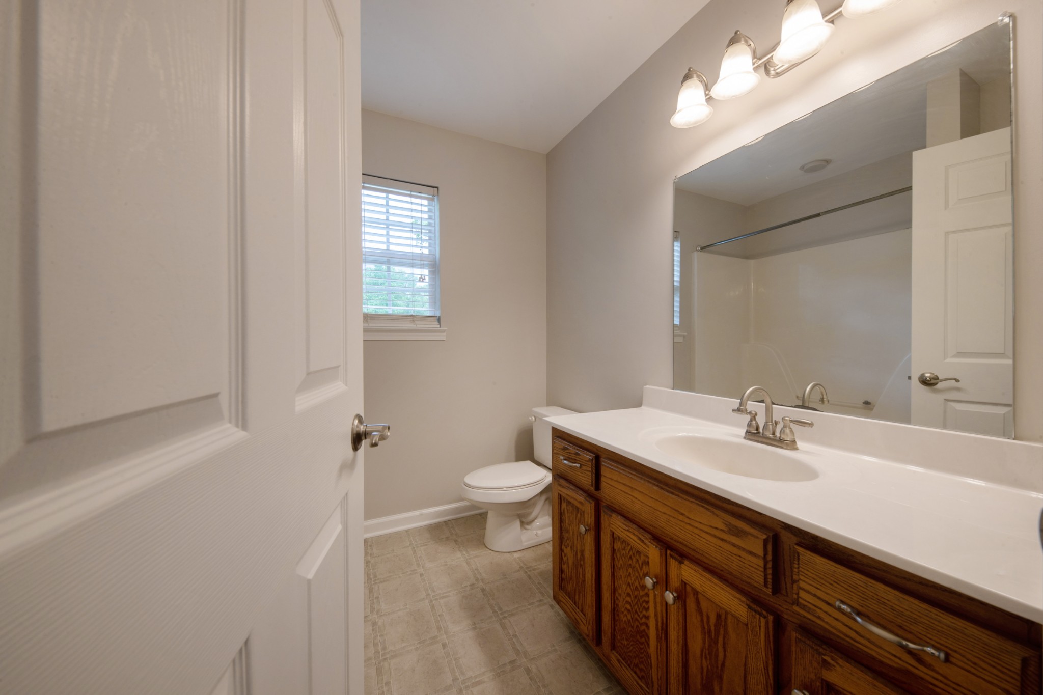 220 Black Road Dickson, TN 37055 - Photo 29 of 36 a bathroom with a sink a toilet and a mirror