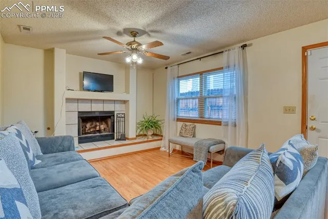 a living room with furniture and a fireplace