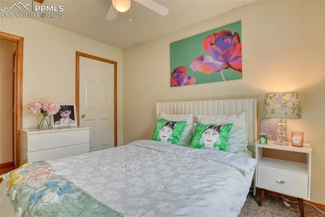 a bedroom with a bed and a painting on the wall