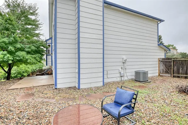 a view of a chair and table in backyard