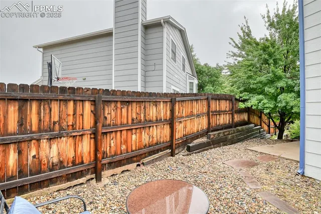 a view of a house with a wooden fence
