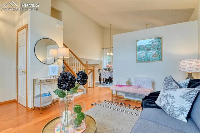 a living room with furniture flowerpot and wooden floor