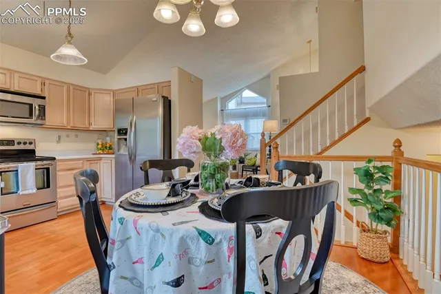 a dining room with furniture potted plants and wooden floor