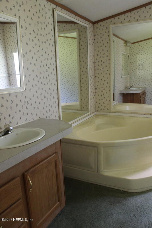 15577 Flounder Road Jacksonville, FL 32226 - Photo 15 of 35 a bathroom with a sink and a bathtub