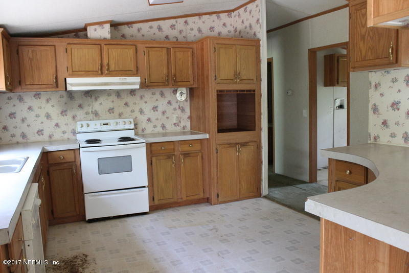 15577 Flounder Road Jacksonville, FL 32226 - Photo 19 of 35 a kitchen with white cabinets and white appliances