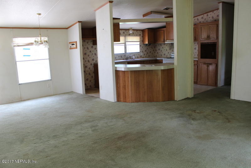 15577 Flounder Road Jacksonville, FL 32226 - Photo 24 of 35 an empty room with windows and cabinet