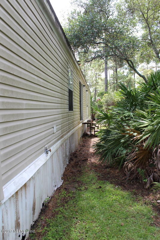 15577 Flounder Road Jacksonville, FL 32226 - Photo 5 of 35 a view of a pathway of a house with a yard