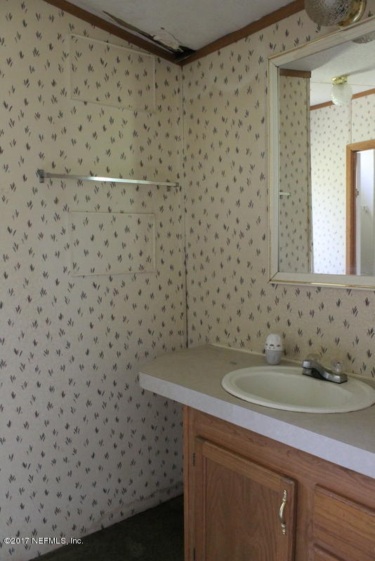 15577 Flounder Road Jacksonville, FL 32226 - Photo 10 of 35 a bathroom with a sink and a mirror