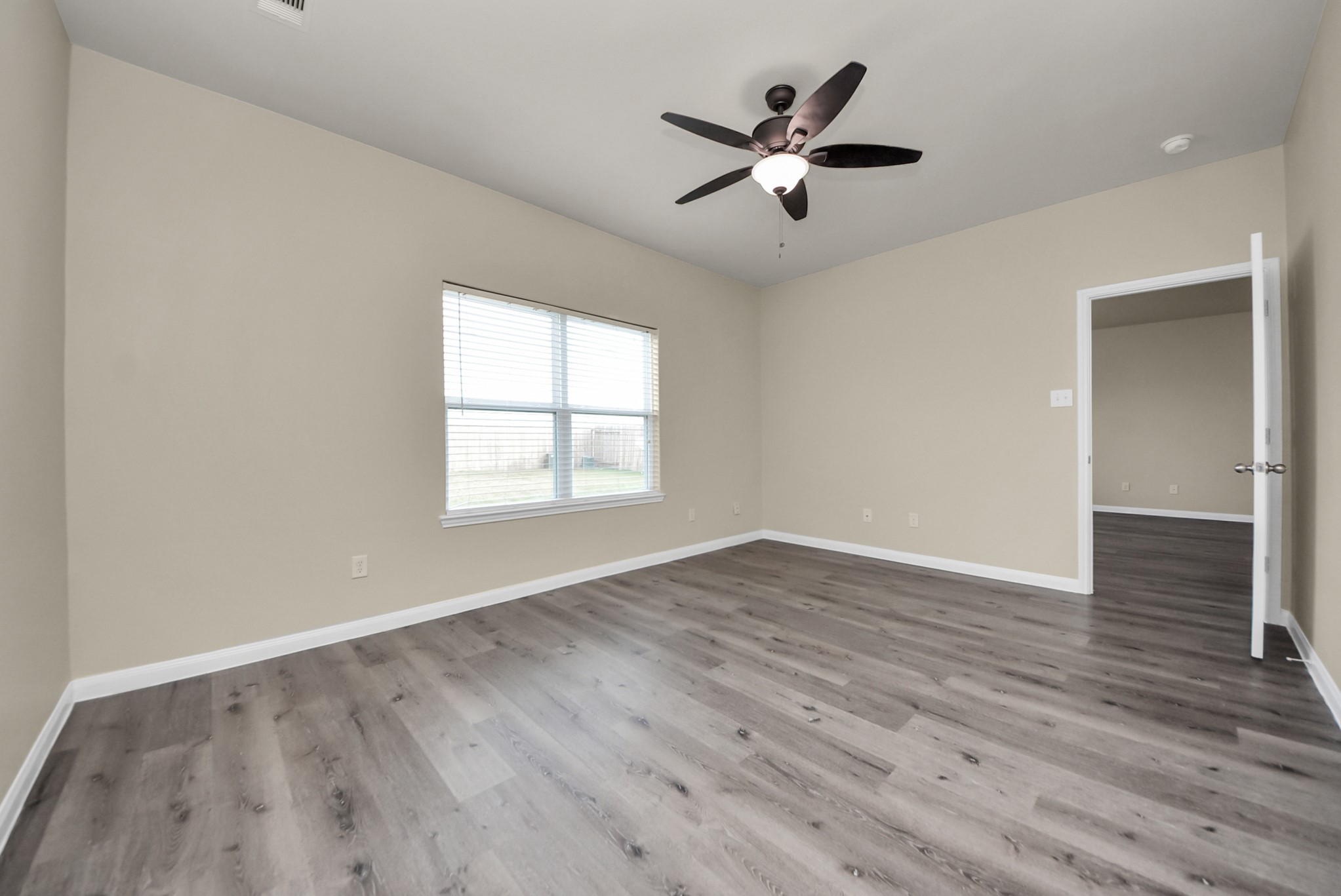 1855 Garnet Breeze Drive Rosharon, TX 77583 - Photo 15 of 40 an empty room with wooden floor and windows