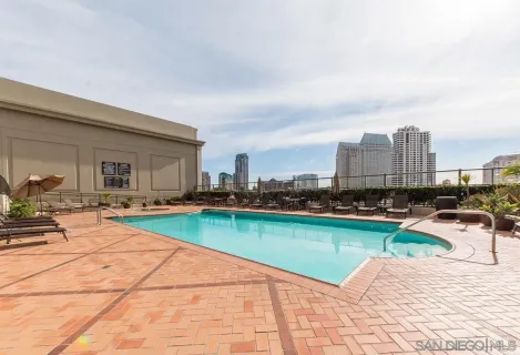 swimming pool with outdoor seating and yard in the back