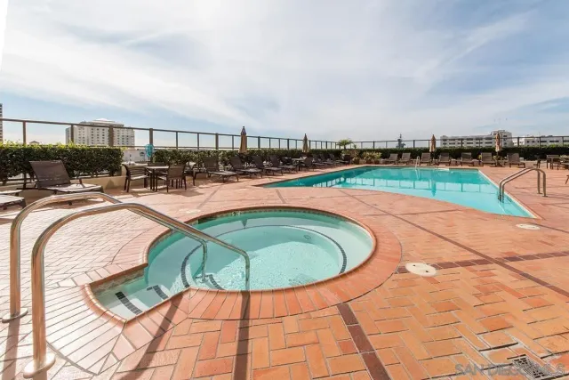 a patio with yard a table and chairs