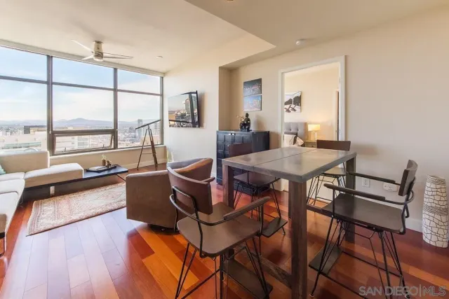 a view of a dining room with furniture and wooden floor