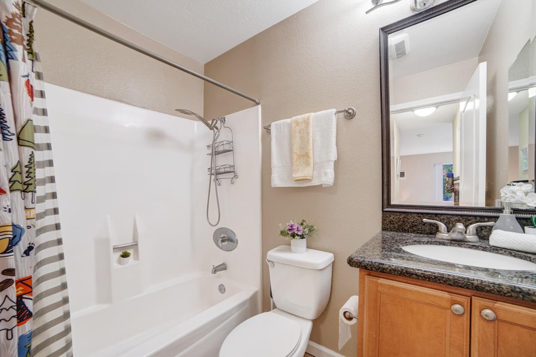 452 Dempsey Road, Unit 253 Milpitas, CA 95035 - Photo 12 of 26 a bathroom with a granite countertop sink toilet and shower