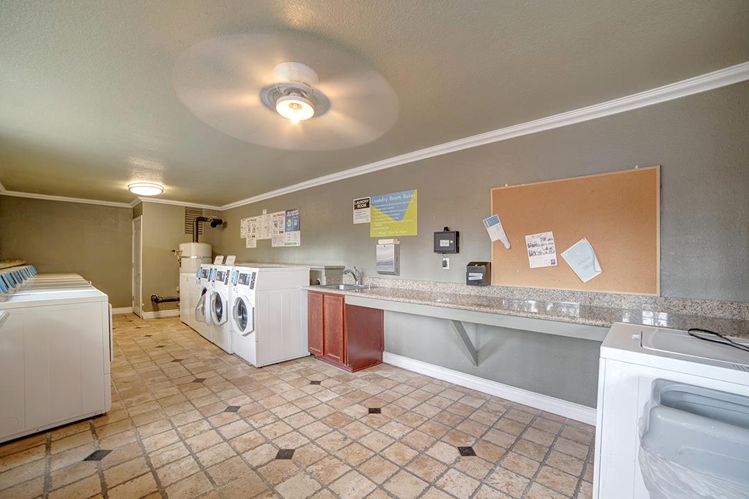 452 Dempsey Road, Unit 253 Milpitas, CA 95035 - Photo 22 of 26 a large white kitchen with a stove a sink dishwasher and a refrigerator with wooden floor
