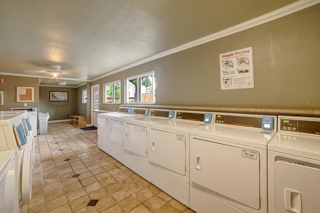 452 Dempsey Road, Unit 253 Milpitas, CA 95035 - Photo 23 of 26 a large white kitchen with sink and washing machine