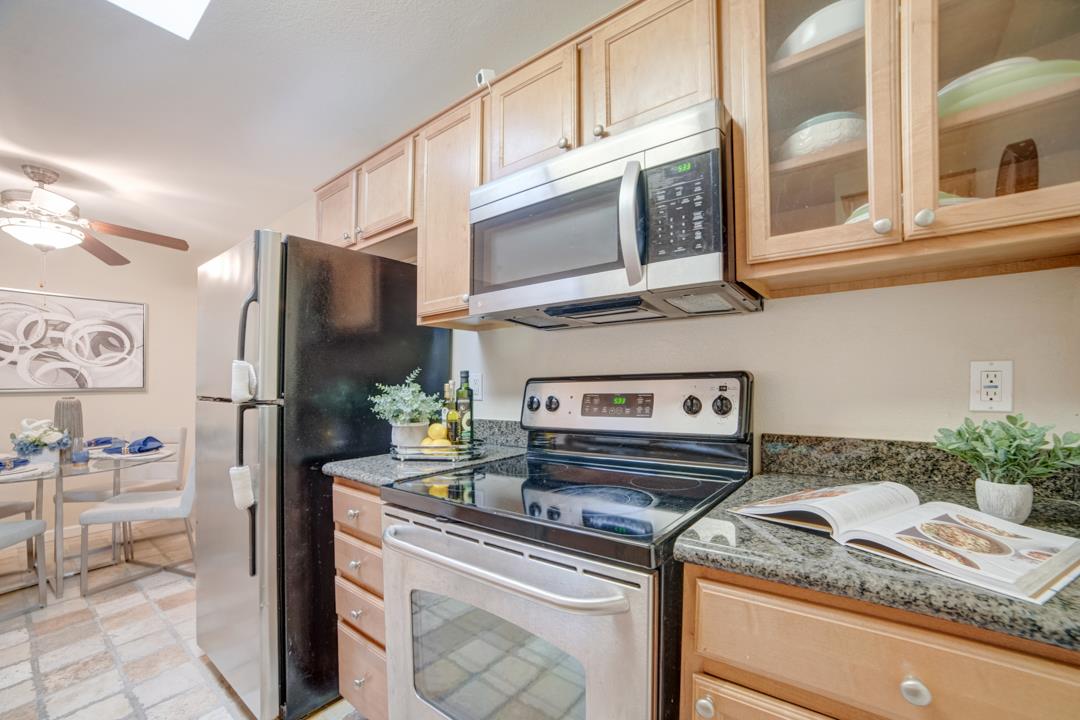 452 Dempsey Road, Unit 253 Milpitas, CA 95035 - Photo 8 of 26 a kitchen with stainless steel appliances granite countertop a sink and a refrigerator