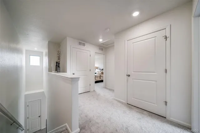 a view of a kitchen with white cabinets and wooden floor