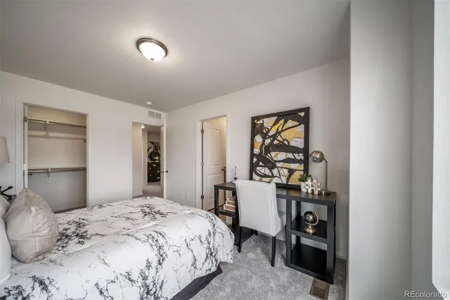 a bedroom with a bed and a dresser