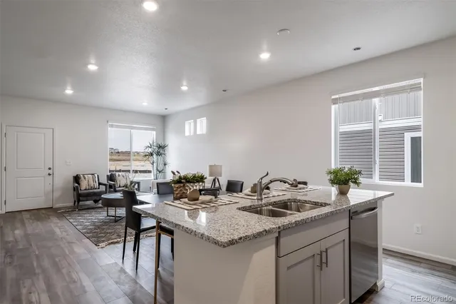 a kitchen with sink and view living room