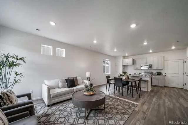 a living room with furniture and kitchen view