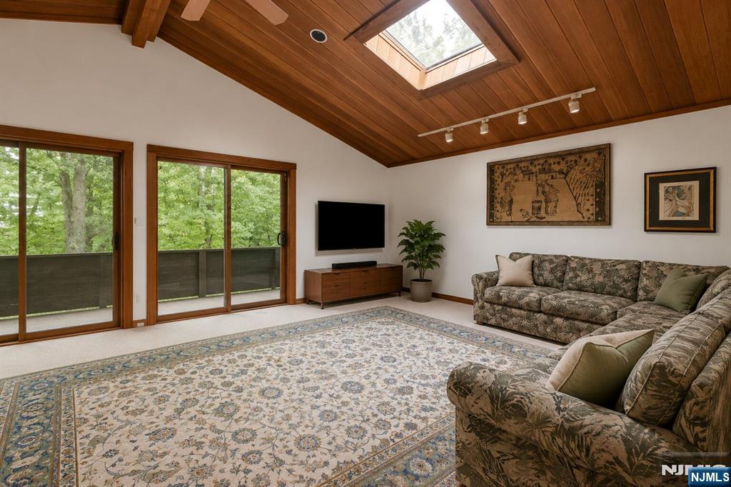 34 Cambridge Way Alpine, NJ 07620 - Photo 22 of 48 a living room with furniture and a flat screen tv