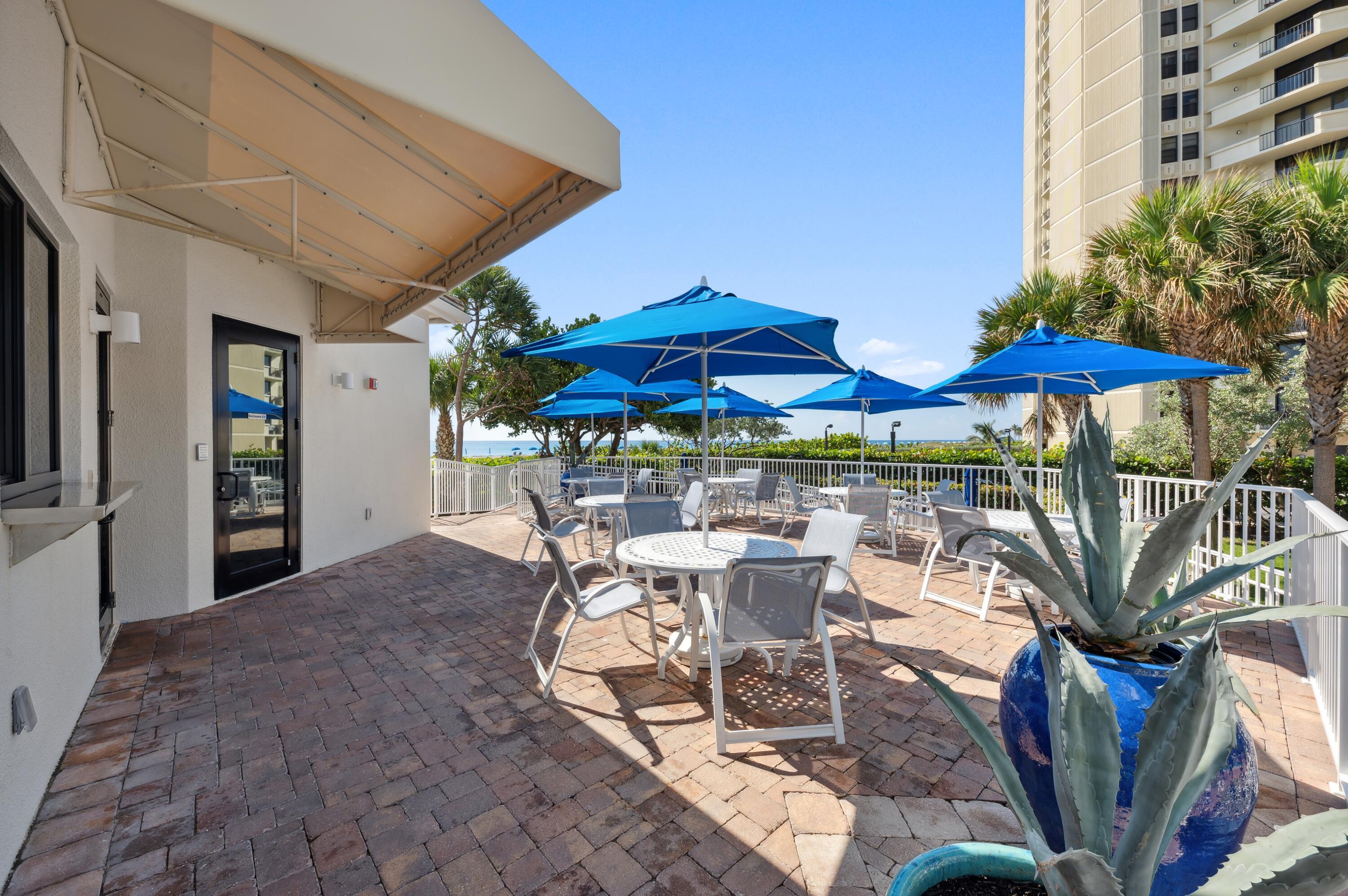3000 North Ocean Drive, Unit 18G Singer Island, FL 33404 - Photo 28 of 46 a view of patio with chairs and table under an umbrella